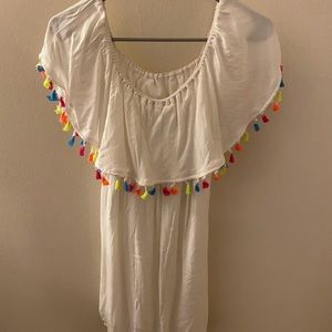 White off-the-shoulder dress with colorful tassels